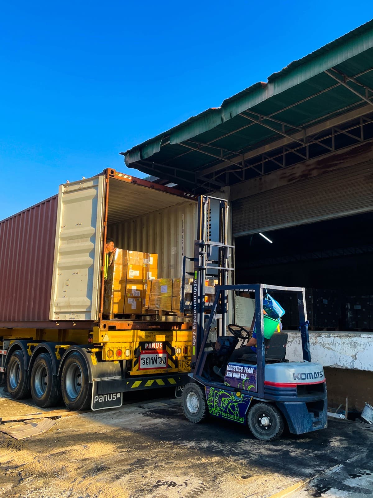 Palletized goods being loaded into a shipping container